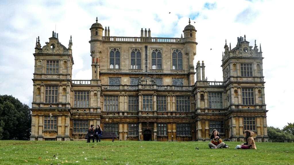 Objevte Nottingham, Robin Hood, Jeskyně a Historické Památky 1 Wollaton Hall, a famous Elizabethan mansion in Nottingham, with people enjoying the park