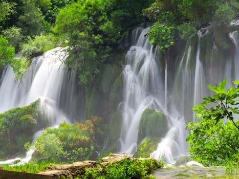 A picturesque waterfall cascades amidst lush greenery in Bosnia and Herzegovina.