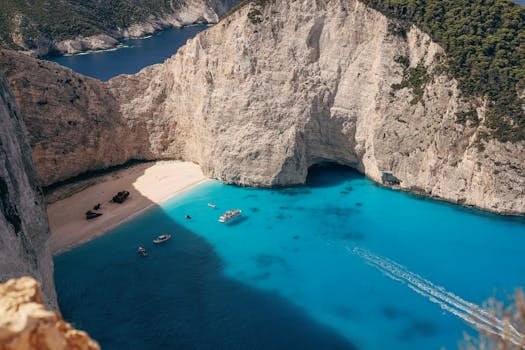 Stunning aerial view of Navagio Beach with crystal clear waters and scenic cliffs in Zakynthos, Greece.