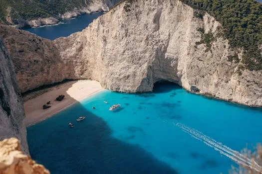 Stunning aerial view of Navagio Beach with crystal clear waters and scenic cliffs in Zakynthos, Greece.