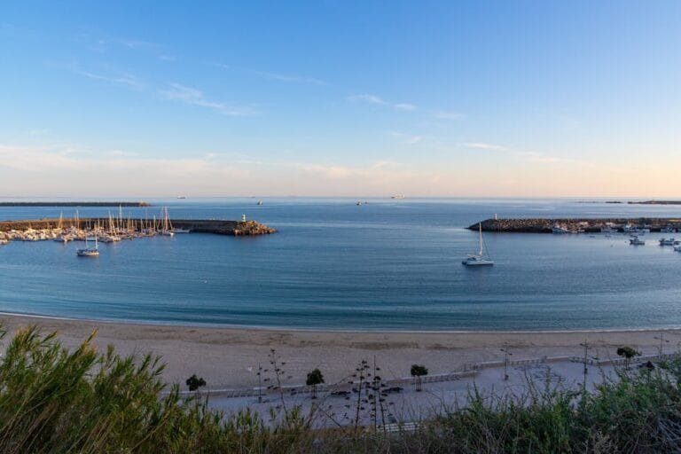 Peaceful coastal scene of Sines Marina and beach at sunrise in Portugal.