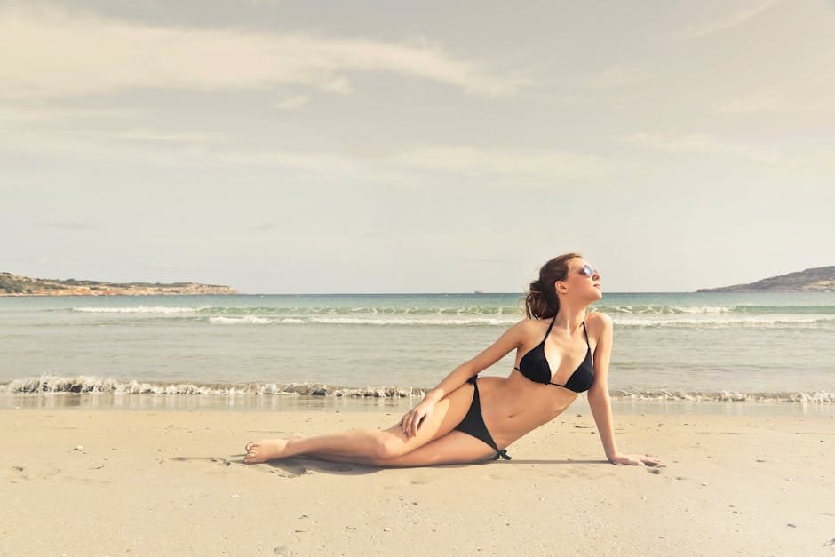 Young woman in a bikini sunbathing on a tropical beach in Malta.