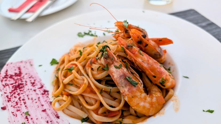 Delicious shrimp linguine served with a rich tomato sauce, perfect for seafood lovers.