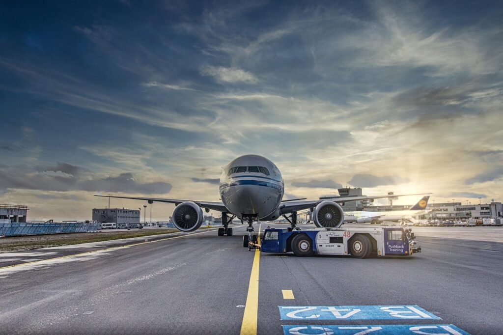 airplane, runway, airport, tarmac, aircraft, vehicle, nature, truck, airliner, clouds, asphalt, jet, flight, transportation system, air travel, outdoor, airline, plane, transportation, travel, airfield