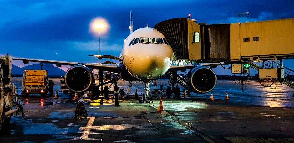 A commercial airplane on the runway at Bengaluru airport during night with a blue sky backdrop.