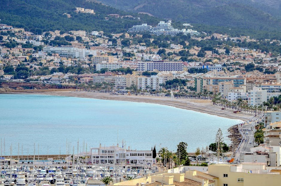 Aerial view of Altea's coastline and marina under a clear sky, showcasing its vibrant architecture.