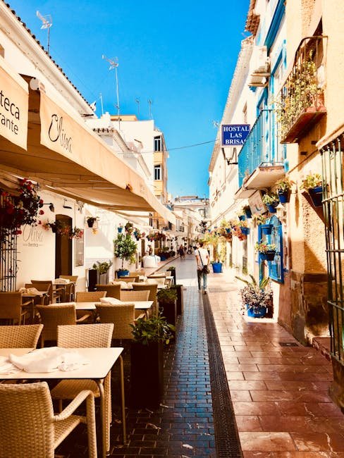 Beautiful street view of Estepona, Spain, featuring outdoor cafés and vibrant architecture.