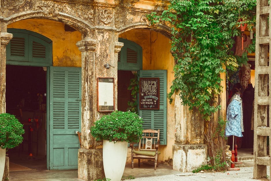 Explore a rustic storefront with vintage shutters, vibrant plants, and charming architectural details.