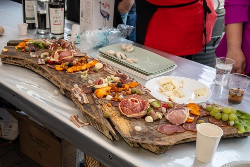 Delicious charcuterie board featuring meats, cheeses, and snacks at an outdoor event in Garešnica, Croatia.